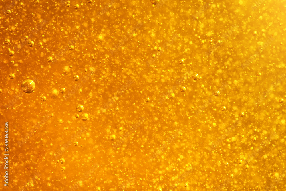 Abstract macro honey bubbles closeup in bright amber color. The texture of the honey. Healthy food concept. Diet. Selective focus. Abstract macro honey bubbles closeup in bright amber color. The texture of the honey. Healthy food concept. Diet. Selective focus.