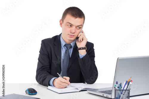 Businessman on the phone at workplace isolated on white background