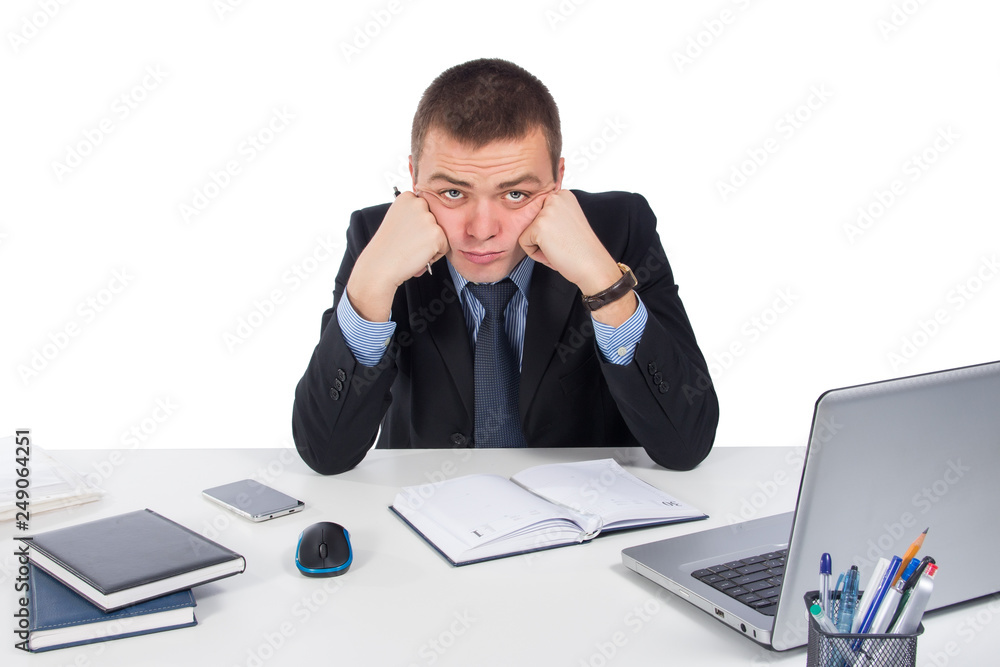 Frustrated young business man working on laptop computer at office  isolated on white background