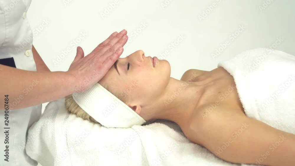 Young attractive woman getting spa treatment over white background