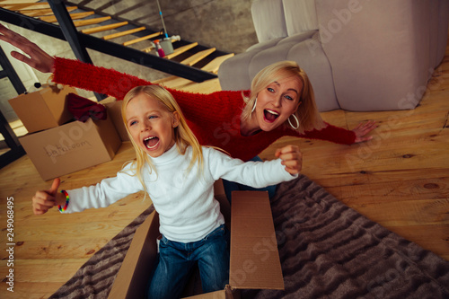 Emotional blonde woman playing with her kid
