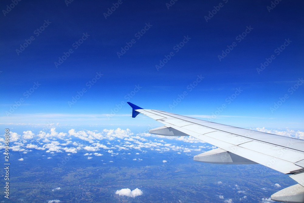 Airplane wing See clouds in the dark sky. Airplane wing See clouds in the dark sky.