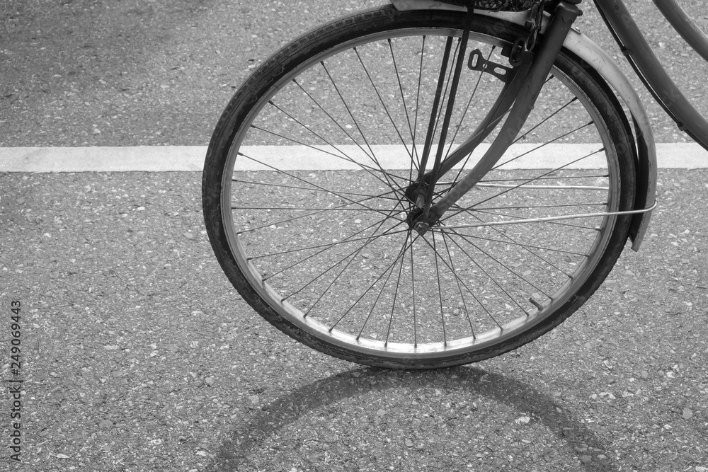 The shadow of a bicycle on the black and white on asphalt road The shadow of a bicycle on the black and white on asphalt road
