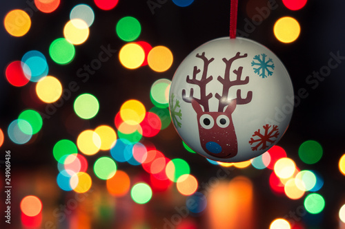 Christmas ball decoration hanging with a bukeh of christmas lights on background photo