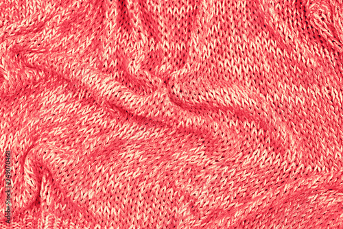 Knitted texture background coral top view flat