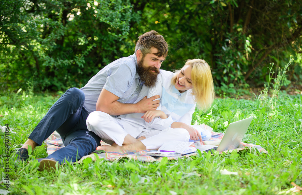 How to balance freelance and family life. Couple youth spend leisure outdoors working with laptop. Couple in love or family work freelance. Modern online business. Freelance life benefit concept How to balance freelance and family life. Couple youth spend leisure outdoors working with laptop. Couple in love or family work freelance. Modern online business. Freelance life benefit concept