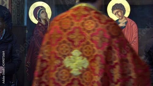 Priest in church burning incense during mass