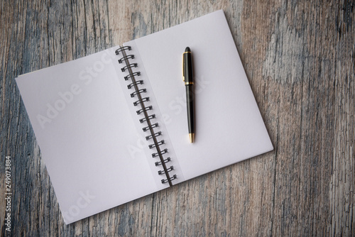 Plain empty notebook, on a black slate background with copy space