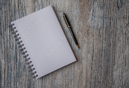 Plain empty notebook, on a wooden background with copy space