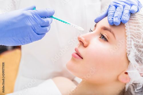 Woman receiving beauty plastic injection on her nose