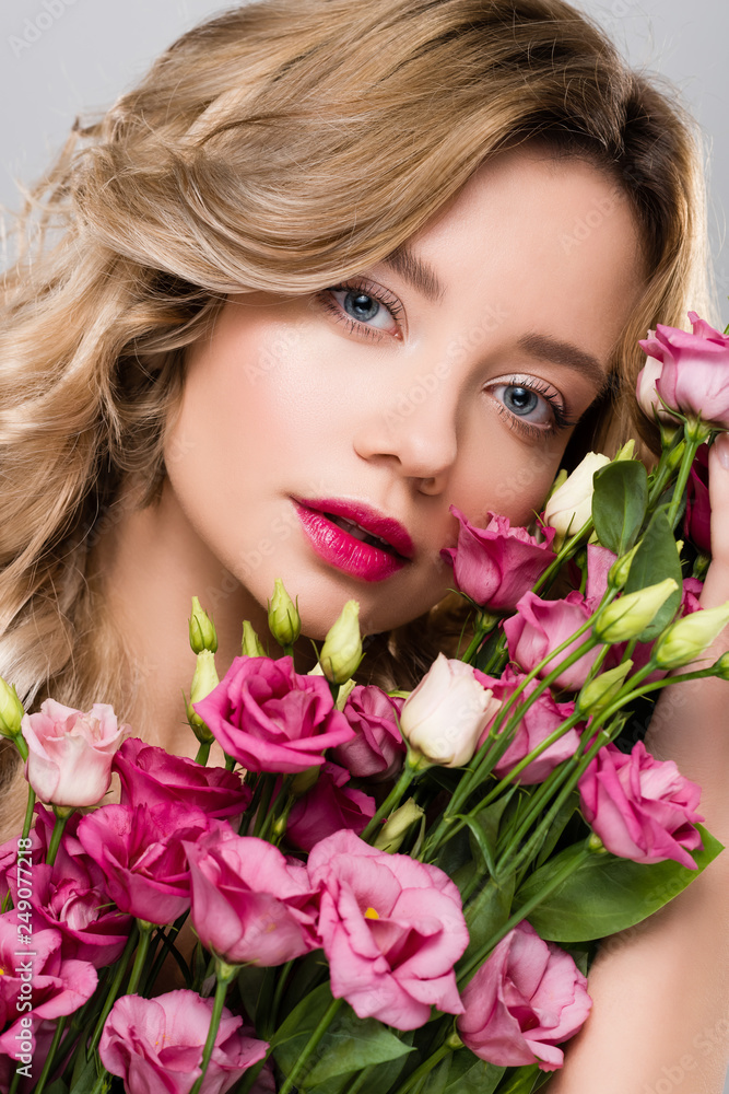beautiful blonde woman posing with spring Eustoma flowers bouquet beautiful blonde woman posing with spring Eustoma flowers bouquet