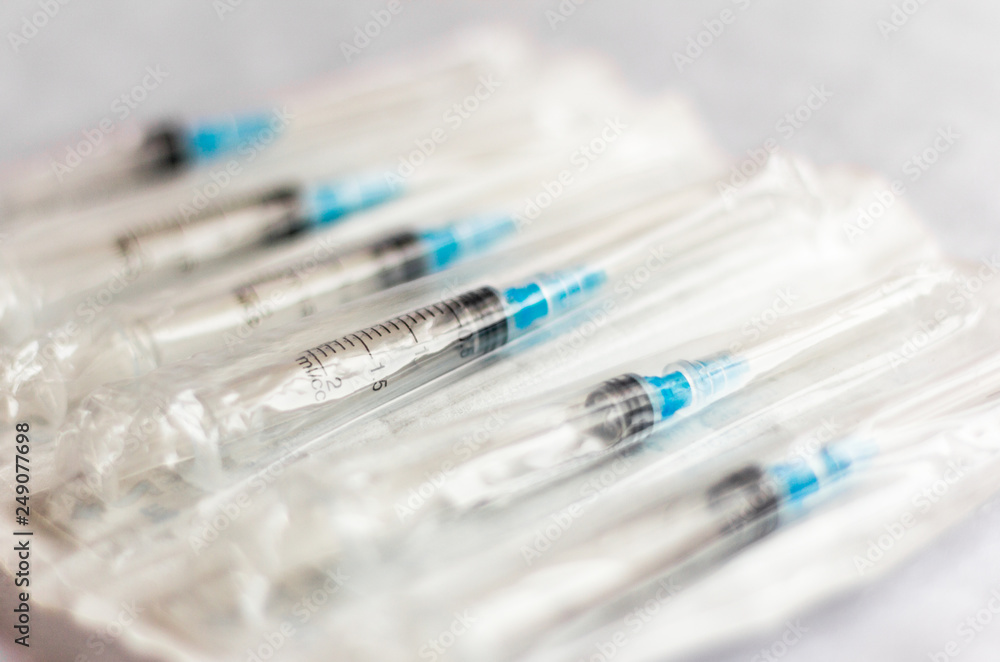 new disposable injection syringes in the package, close-up, selective focus new disposable injection syringes in the package, close-up, selective focus