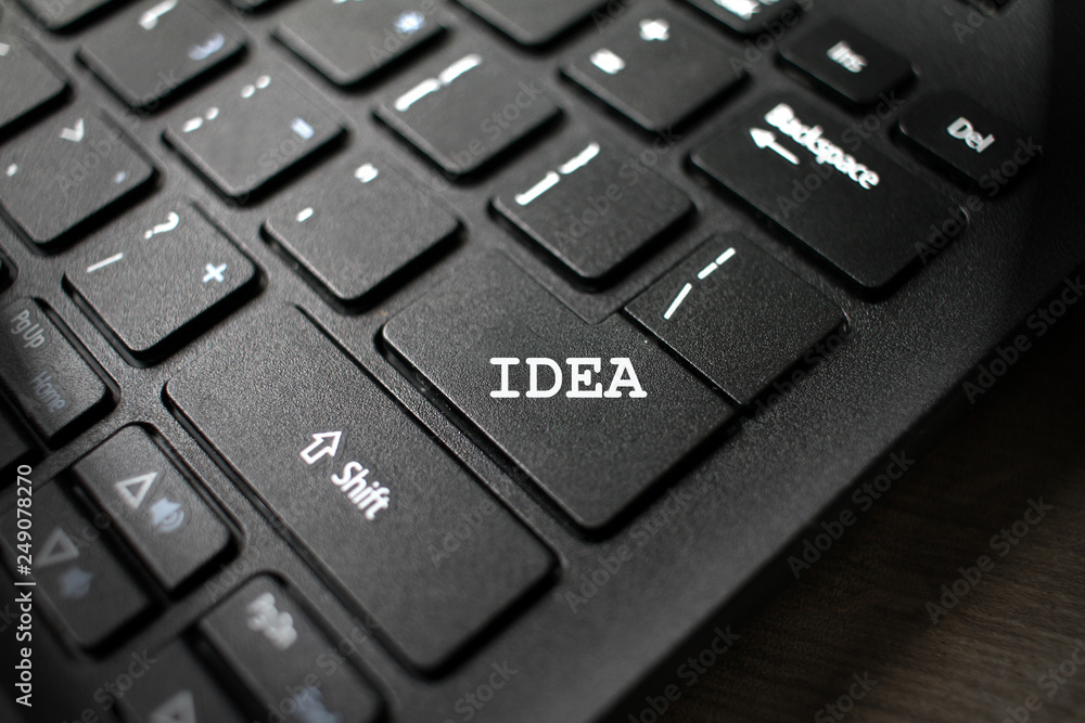 Enter button on laptop keyboard with sign IDEA and light bulb. Enter keyboard key button on a computer. Close up of Enter key of Laptop computer. Enter button on laptop keyboard with sign IDEA and light bulb. Enter keyboard key button on a computer. Close up of Enter key of Laptop computer.