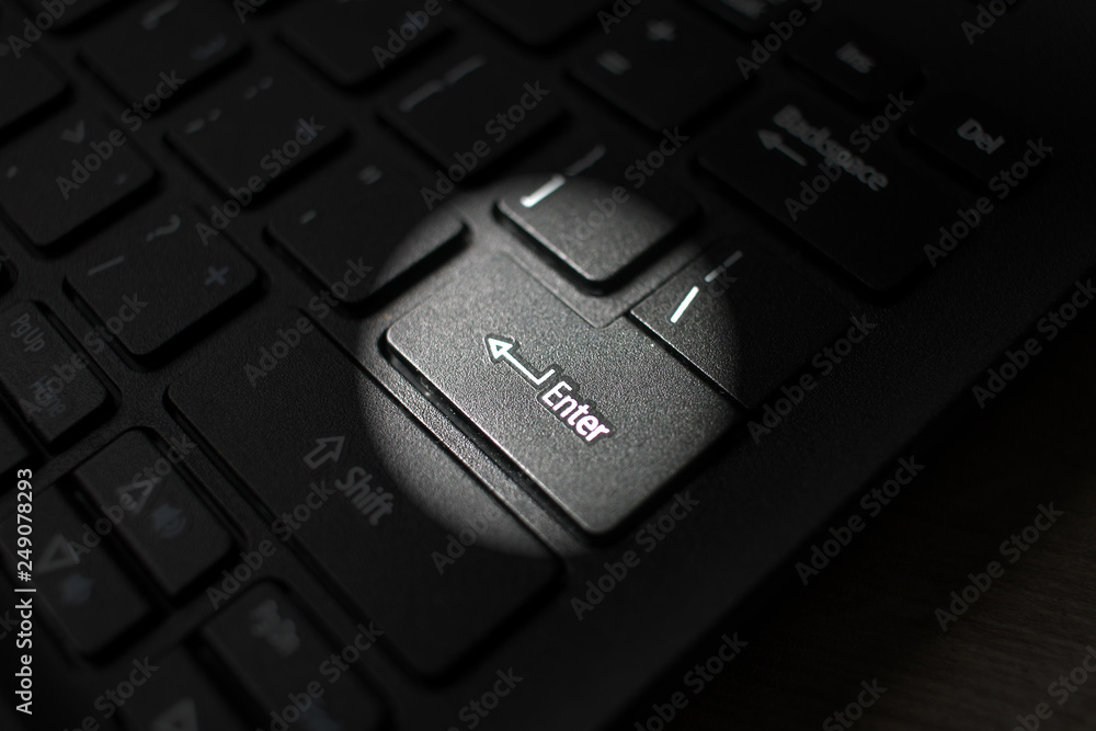 Enter button on laptop keyboard. Close up of Enter key of Laptop computer. Enter keyboard key button on a computer with light effect. Enter button on laptop keyboard. Close up of Enter key of Laptop computer. Enter keyboard key button on a computer with light effect.