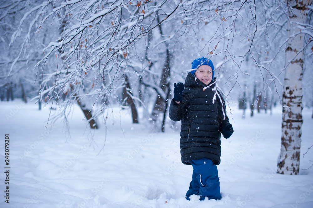 a child in a winter Park playing with snow