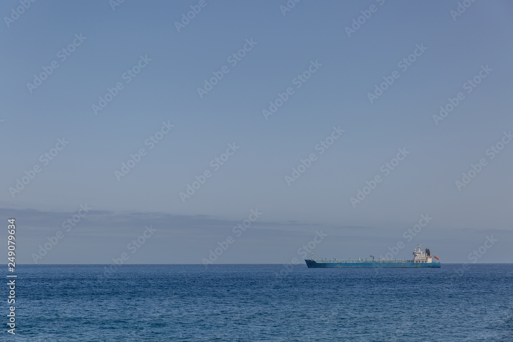 View of a huge distant ship in a calm sea with a clear sky