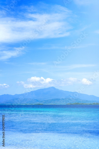 Beautiful ocean scene view isolated with light blue sky background, concept of vacation and sea travel, copy space