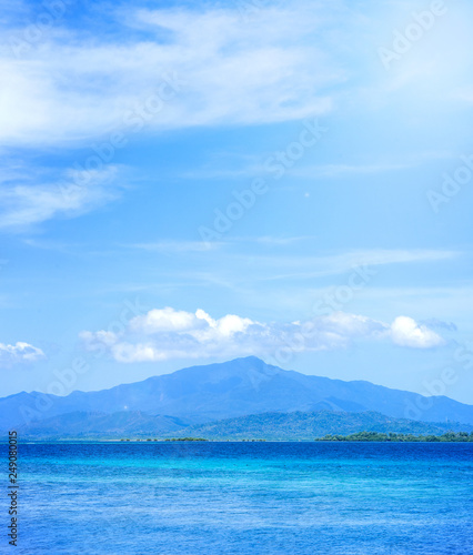 Beautiful ocean scene view isolated with light blue sky background, concept of vacation and sea travel, copy space