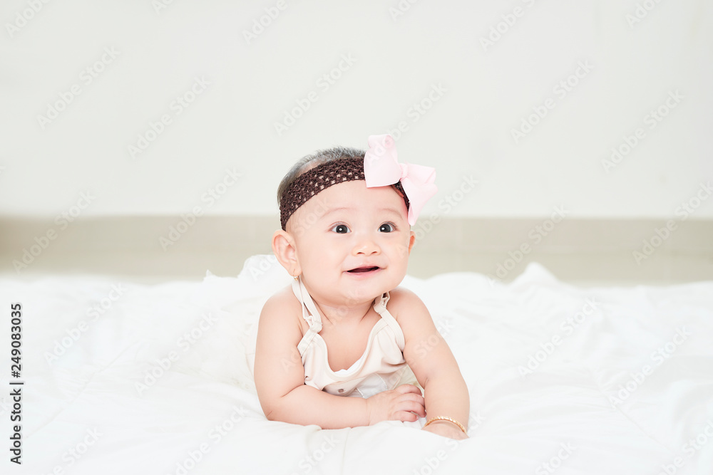 Baby girl smiling on the floor isolated on white Baby girl smiling on the floor isolated on white
