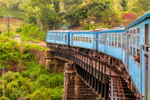 Train from Nuwara Eliya to Kandy among tea plantations in the highlands of Sri Lanka.