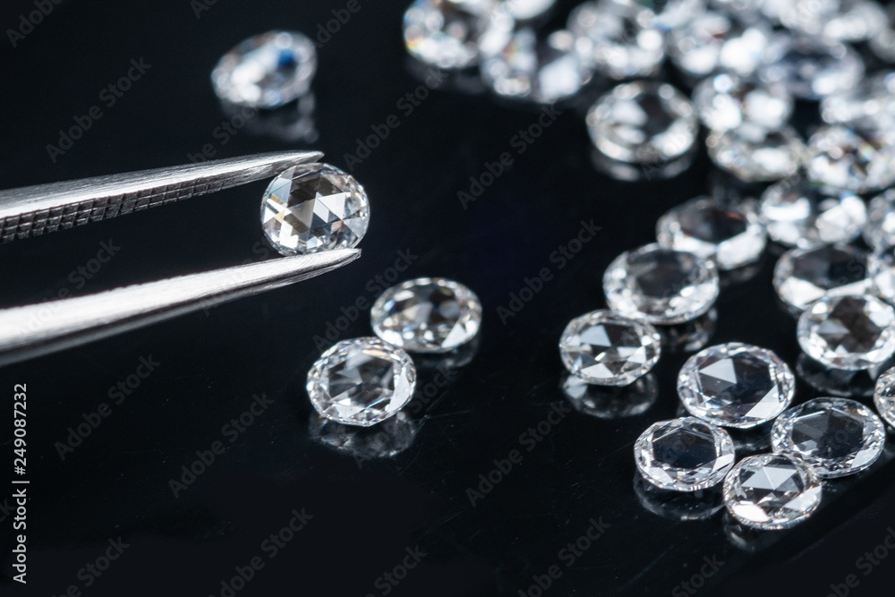 old cut diamonds with tweezer on black background old cut diamonds with tweezer on black background