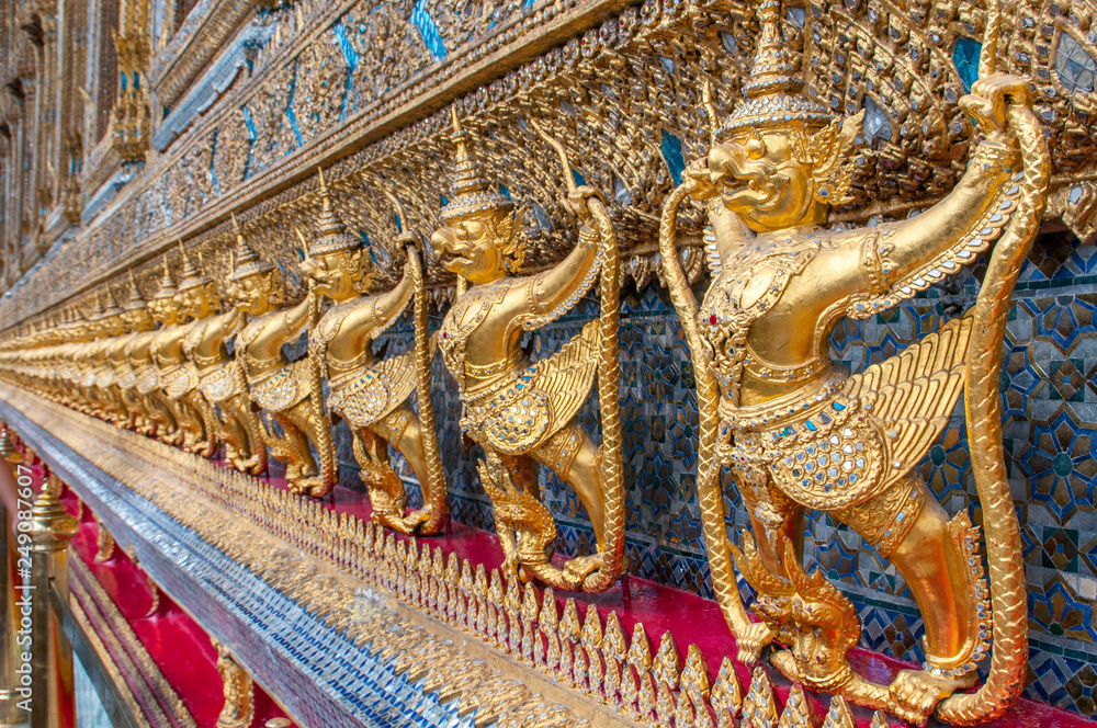 Garudas and nagas on external decorations of the Ubosoth, Wat Phra Kaew temple, Grand Palace, Bangkok, Thailand.