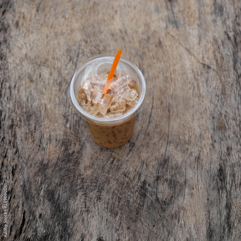Ice coffee on wooden table Ice coffee on wooden table