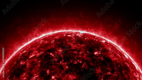 A close zooming shot of the upper part of a red giant star burning extremly hot. photo