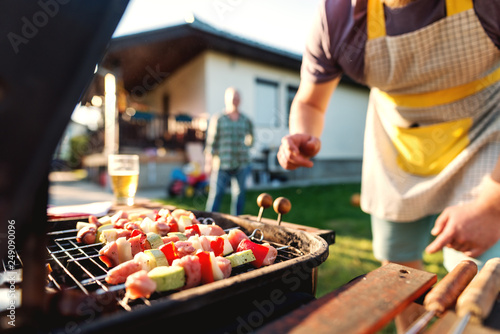 Close up of grilled vegetables and meat on sticks on grill. Family gathering concept.