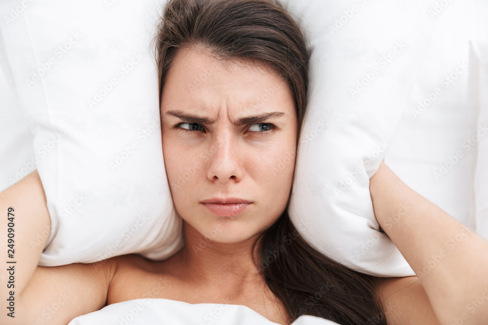 Top view close up of a beautiful young woman laying in bed Top view close up of a beautiful young woman laying in bed