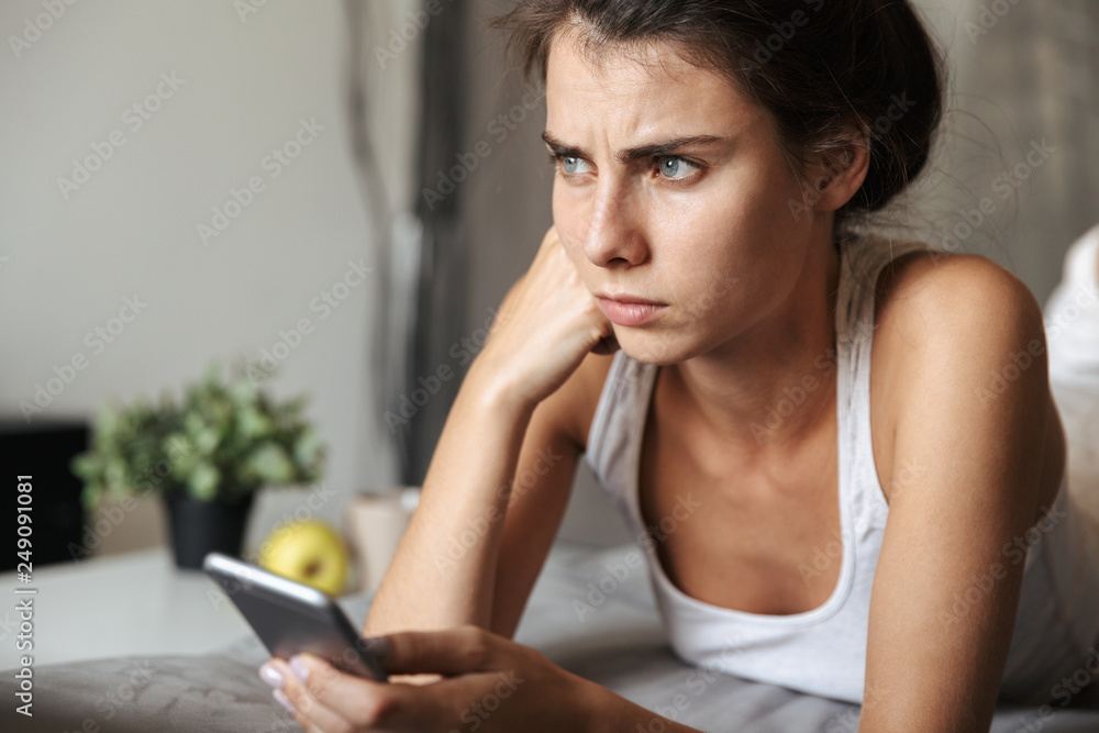 Beautiful upset young woman laying on a couch at home Beautiful upset young woman laying on a couch at home