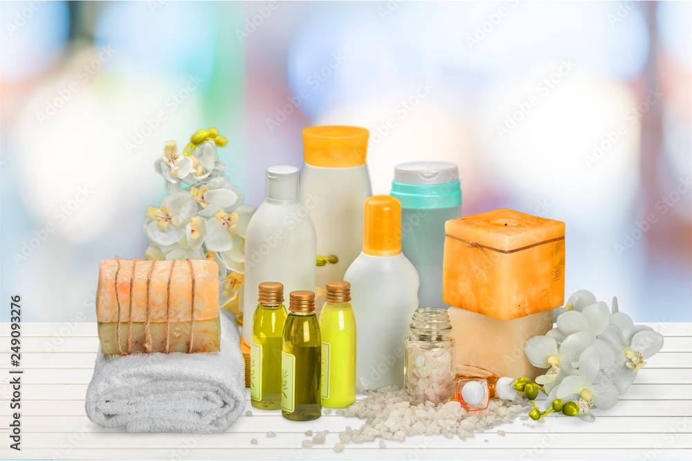 Bath towel and basket with accessories for spa on blur background