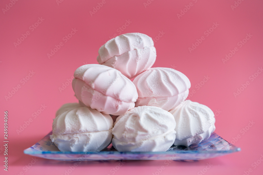 Pink and white marshmallows on a pink background Pink and white marshmallows on a pink background