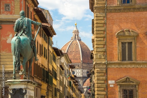 Cathedral of Santa Maria del Fiore and Monument of Cosimo de Medici. View from the Piazza of the Santissima Annunziata. Beautiful sunny day in Florence, Italy.