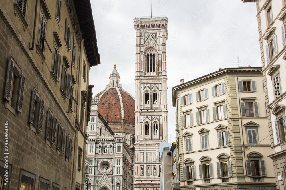 Basilica di Santa Maria del Fiore with Giotto campanile tower bell and Baptistery of San Giovanni. View from street of Florence, Italy.