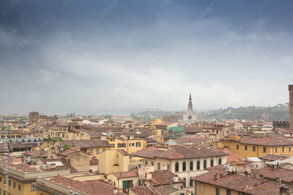 Dramatic colorful aerial view of the beautiful city of Florence. Colorful rainy cityscape with dark blue clouds. Florence, Italy.