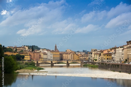 The Arno river and the cloudy Florence. Rainy weather with dark blue clouds hanging over the Italian city - Florence.