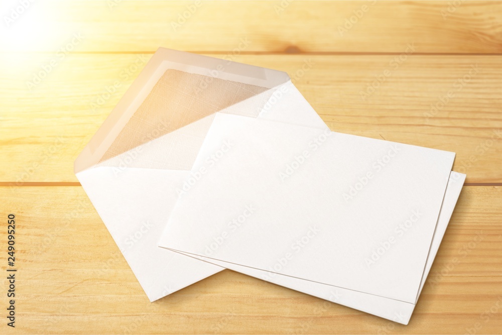 Blank white envelope and card on wooden background Blank white envelope and card on wooden background