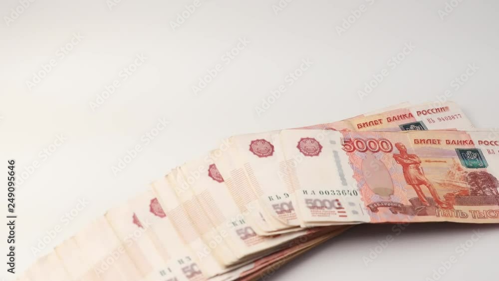 A scattering of many banknotes of five thousand Russian rubles on a white background A scattering of many banknotes of five thousand Russian rubles on a white background