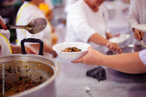 Hands holding food: Hunger problems are assisted by people in society.