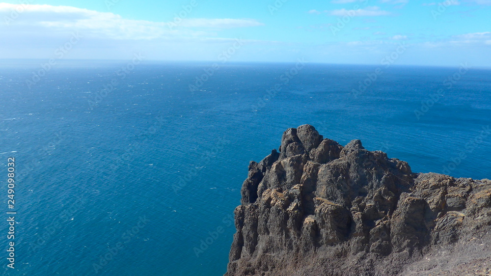 Black lava rock in front of blue sea on the island of Lanzarote,