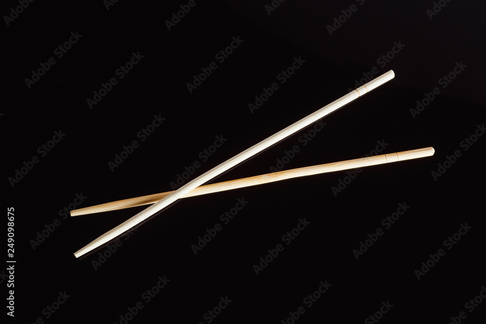 Fototapeta premium Chopsticks on a black background..Traditional Japanese cuisine
