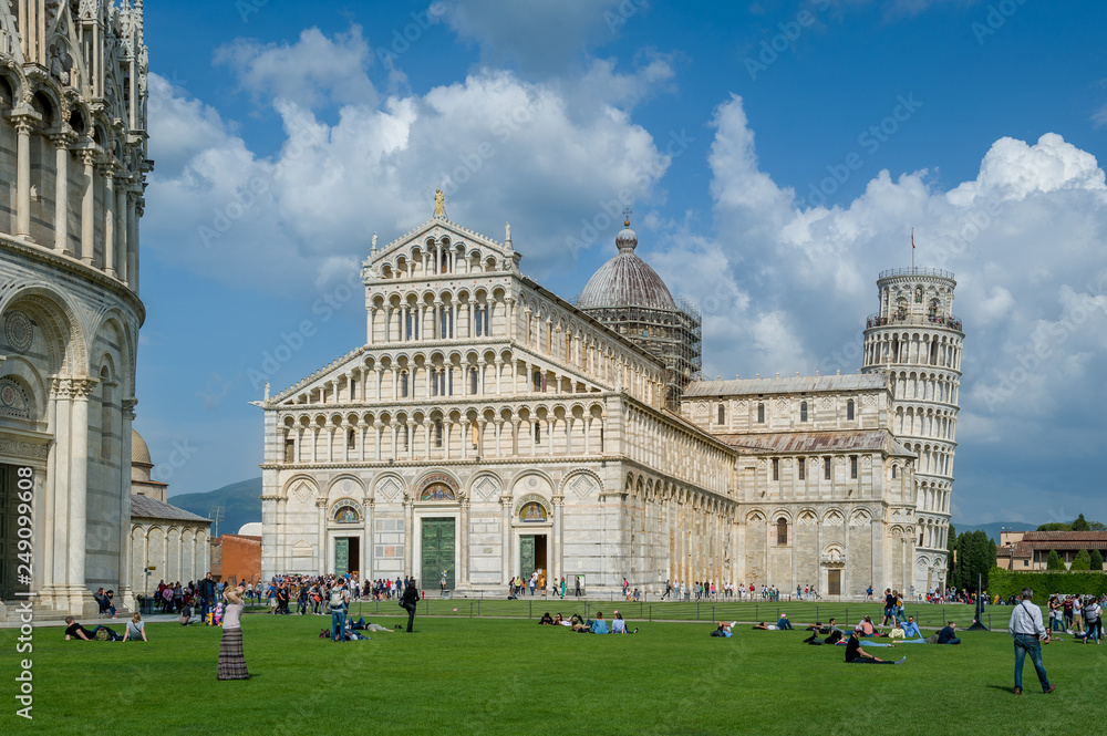 Tourists at central square of Pisa with Pisa Tower and Duomi di Pisa view. Toscana, Italy