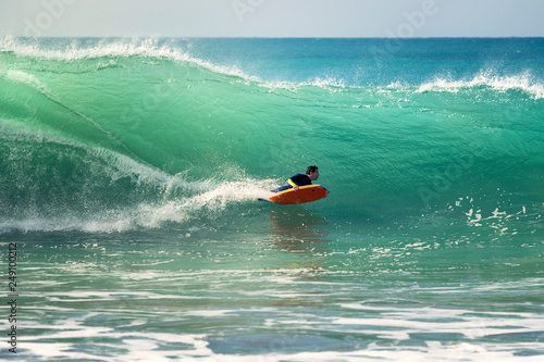 Photography man surfing a big wave at full speed