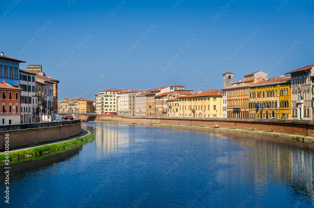 Calm waters of Arno river in the center of Pisa. Toscana province, Italy.