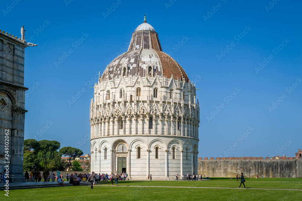 Tourists are visiting Pisa Baptistery and Duomo di Pisa landmarks. Toscana, Italy