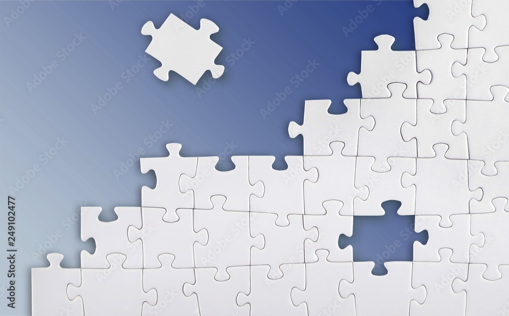 White puzzle pieces on grey background White puzzle pieces on grey background