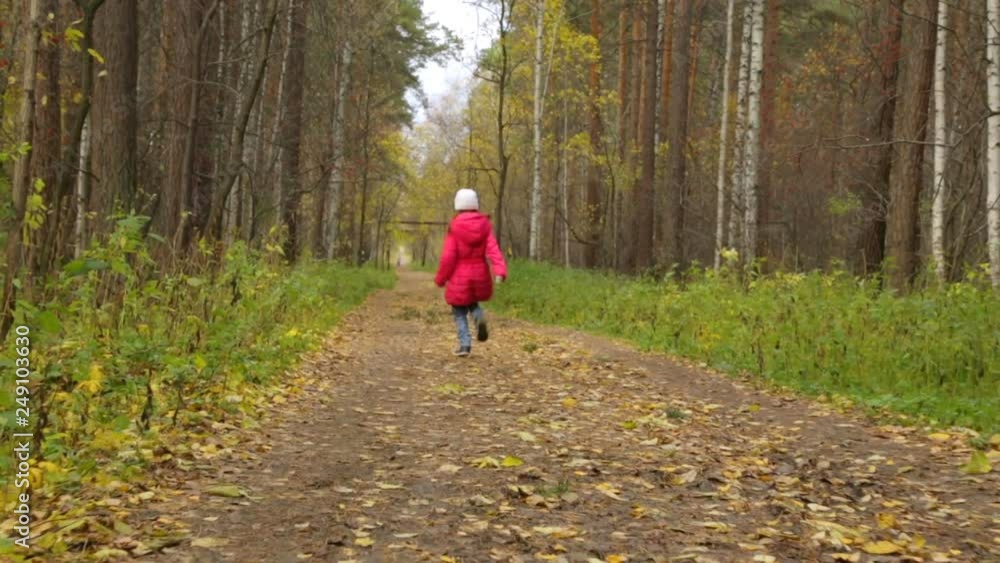 Little girl is running in autumn park Little girl is running in autumn park