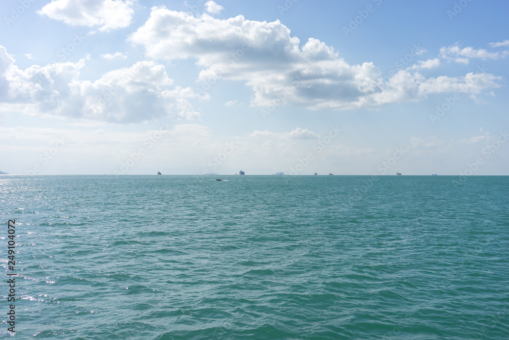 Fototapeta premium Ships in the raid on the horizon under the clouds