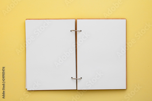 Blank notebook on yellow background, copyspase